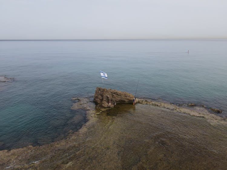 Israeli Flag Stuck In A Rock In The Sea 