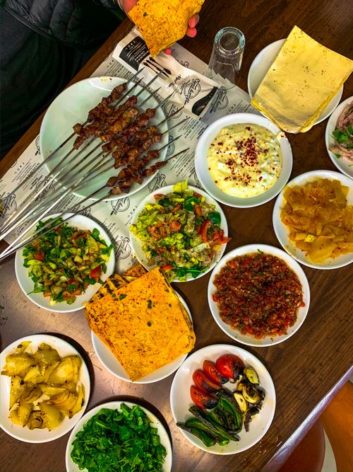 Free A vibrant variety of Mediterranean dishes arranged on a wooden table, perfect for a feast. Stock Photo