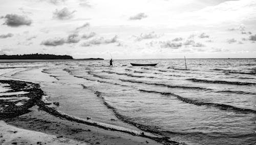 Free Grayscale Photo of Person Fishing on Beach Stock Photo