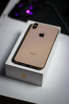 Chic display of smartphone on branded box with sleek design and logo.