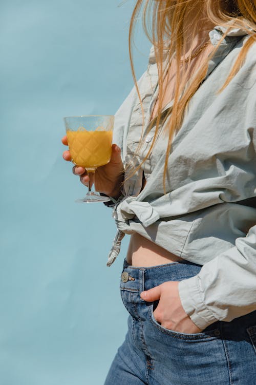 Closeup of a Blonde with a Glass of Orange Juice