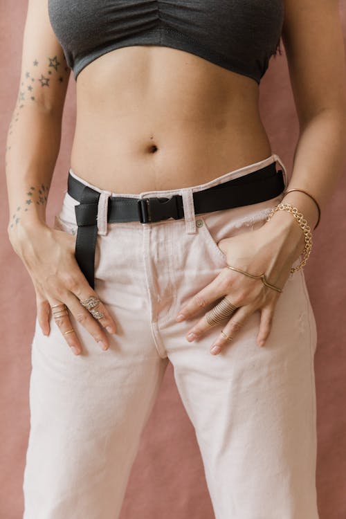 A Woman in White Denim Jeans with Her Hands in Her Pockets