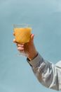 Person Holding Clear Wine Glass With Yellow Liquid