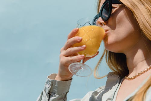 A Woman Drinking Orange Juice