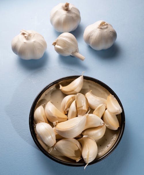 Fresh Garlic Bulbs on Blue surface