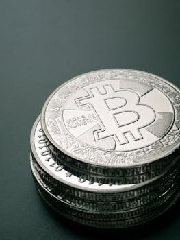 Close-up image of a stack of silver Bitcoin coins, symbolizing digital currency and financial investment.