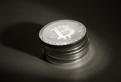 Free A stack of metallic Bitcoin cryptocurrency coins showcased on a dark surface, highlighting financial investment themes. Stock Photo