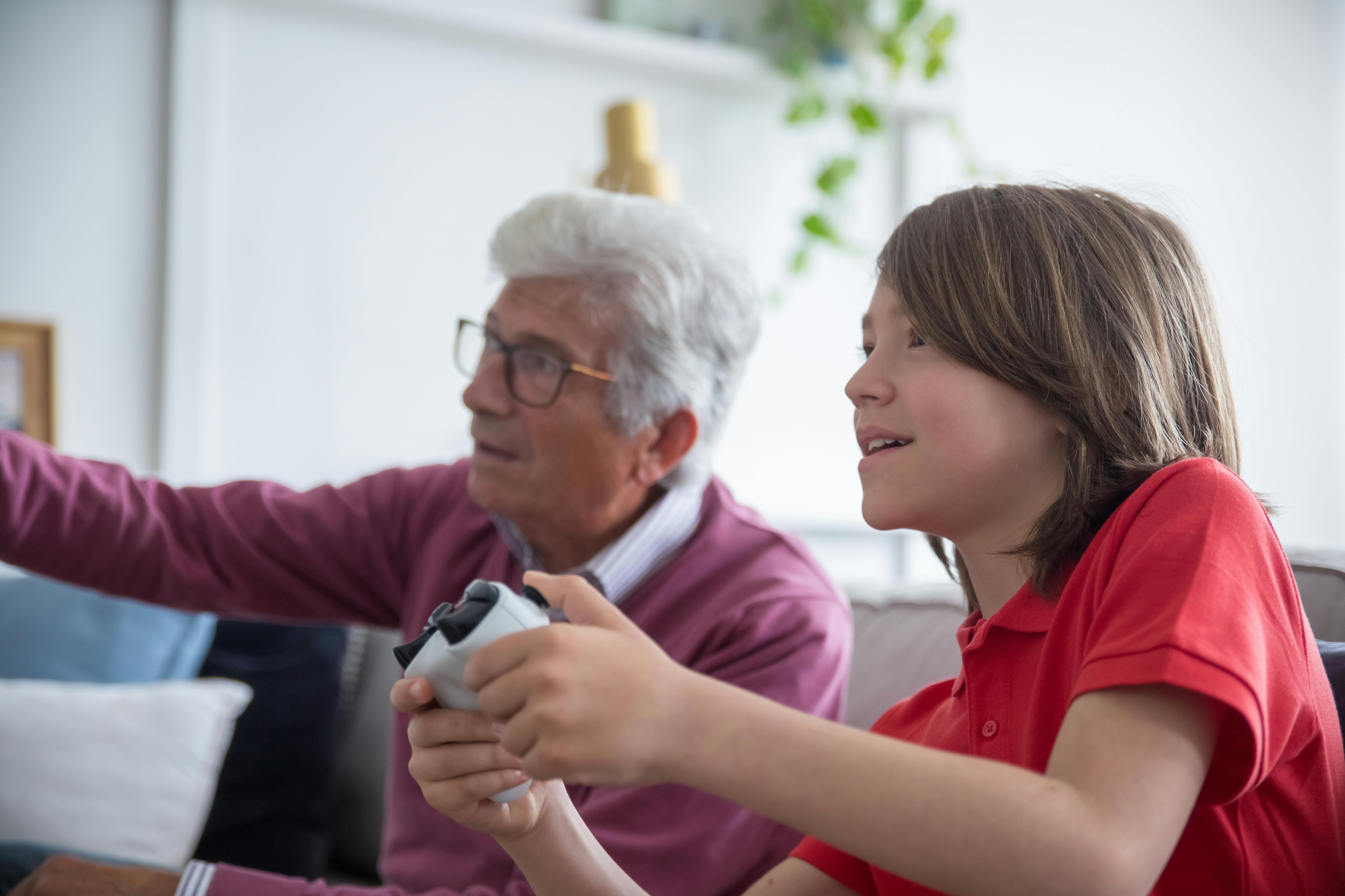 elderly man playing with games with his grandson