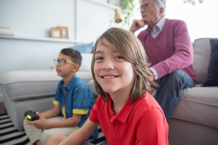 Grandfather And Children Playing A Video Game 