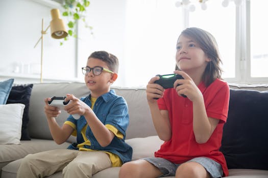 Two kids playing video games on a cozy couch indoors, showcasing fun and technology.