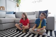 Two Young Boys Sitting on Striped Rug