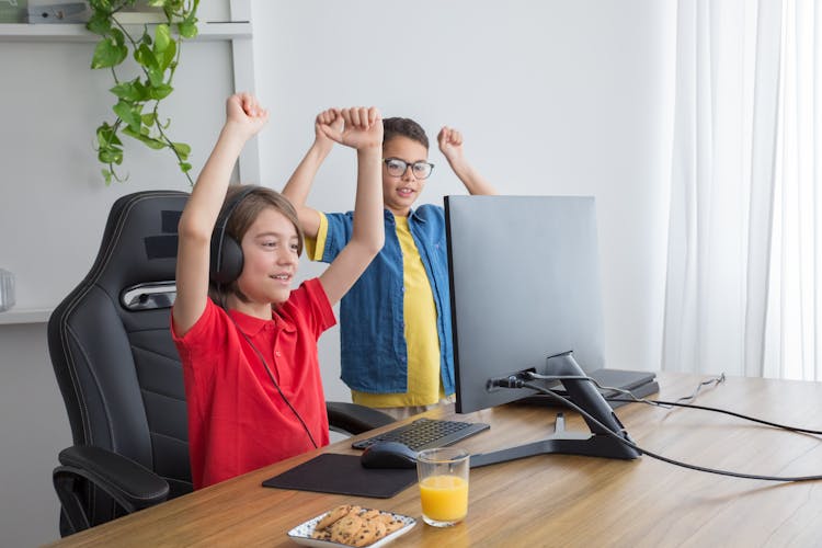 Happy Kids Raising Their Hands 