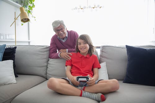 Man and Child Sitting on Gray Couch