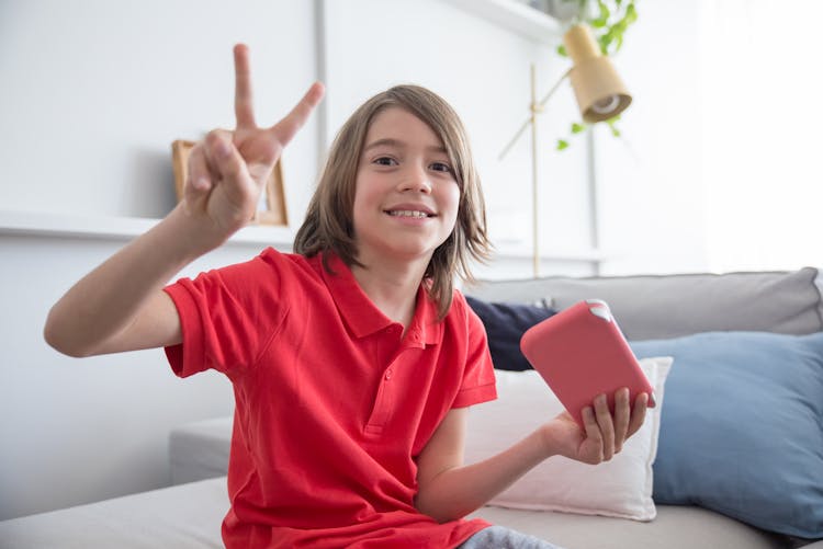 Kid Holding A Smartphone