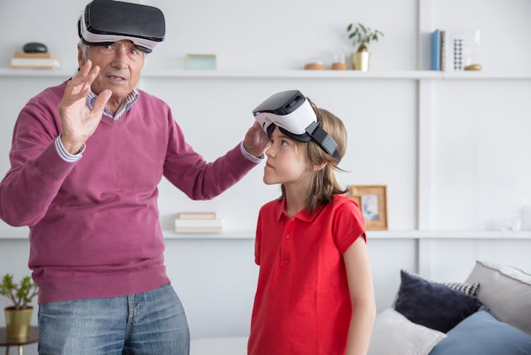 An Elderly Man And His Granddaughter Wearing VR Goggles
