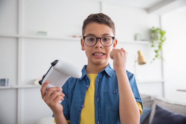 A Boy Holding A Controller