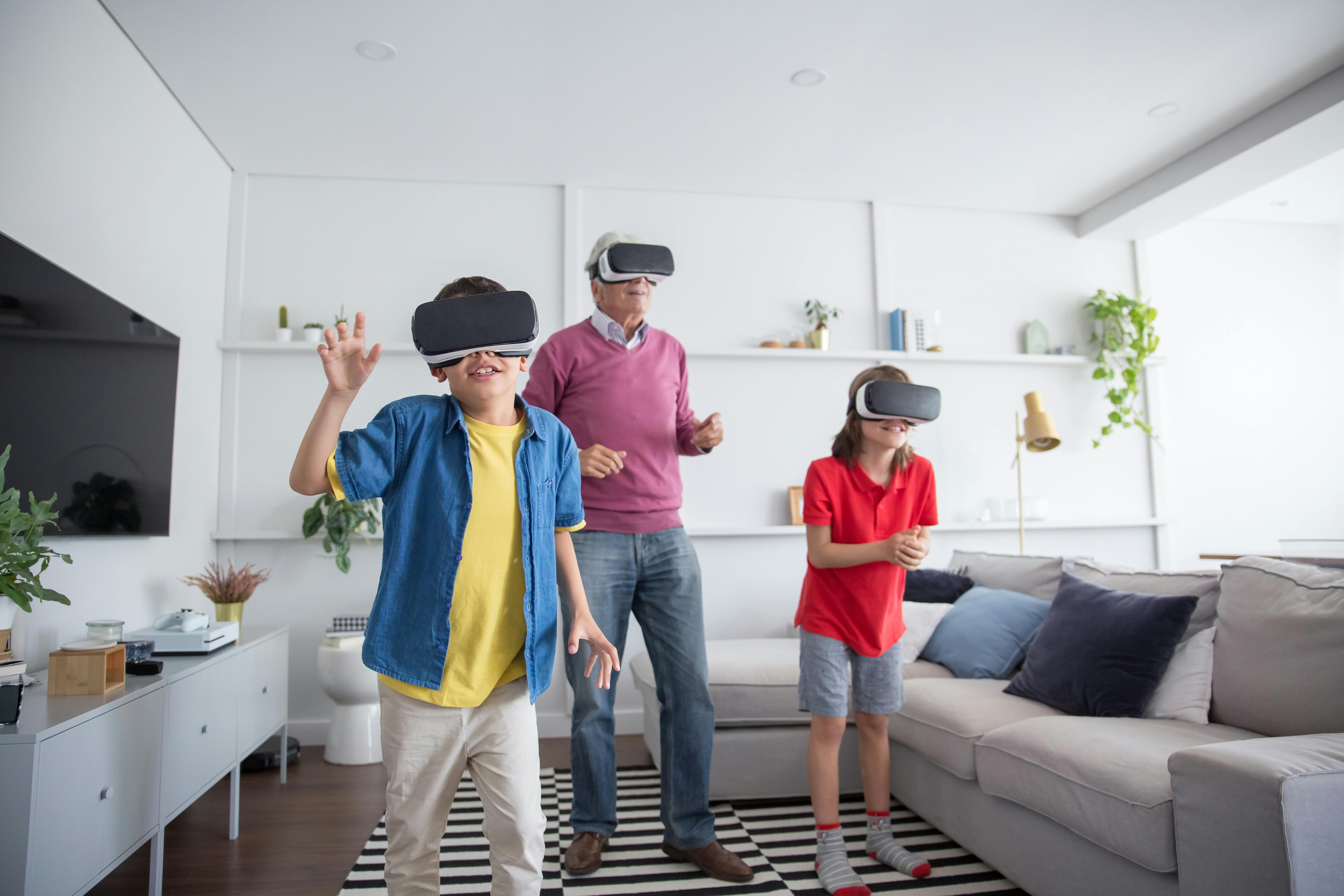 a man and two boys using virtual reality headset