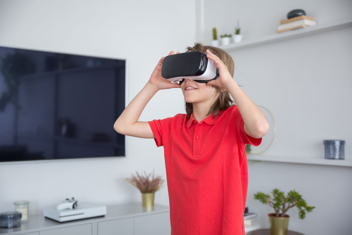 Student smiling while using a VR headset at home