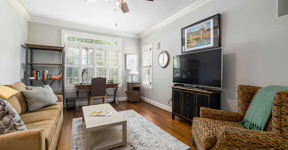 Cozy modern living room with furniture, TV, and decor elements.