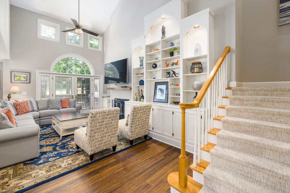 Bright, spacious living room with modern design, featuring a cozy sofa set and elegant decor.