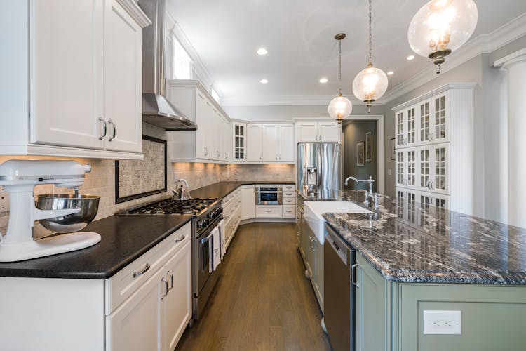 Spacious Bright Kitchen With Marble Island In Middle