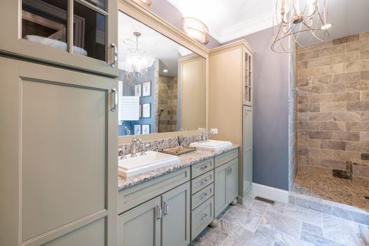 Contemporary bathroom featuring stylish cabinetry and a sleek walk-in shower.