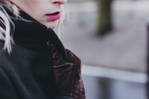 Free Woman Wearing Brown Suede Gloves Holding Her Coat Stock Photo