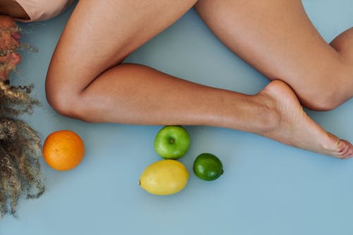 A Woman Lying Beside the Citrus Fruits