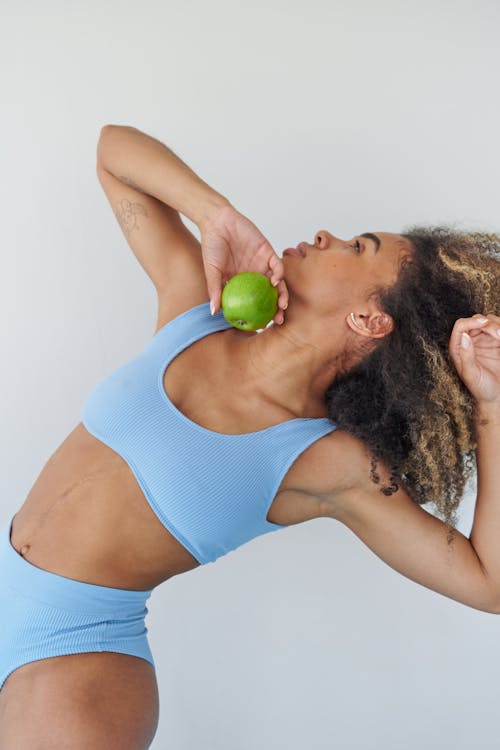 Woman Stretching with Fruit