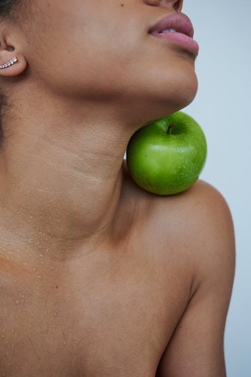 Green Apple on Persons Shoulder