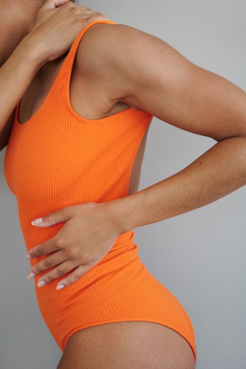 Close-up of a Woman Wearing an Orange Swimsuit 