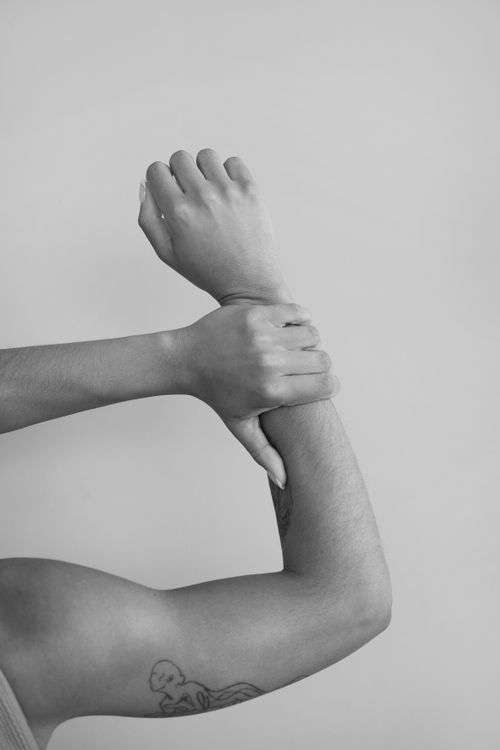 Free Close-up of a tattooed arm in black and white, emphasizing motion and body art. Stock Photo