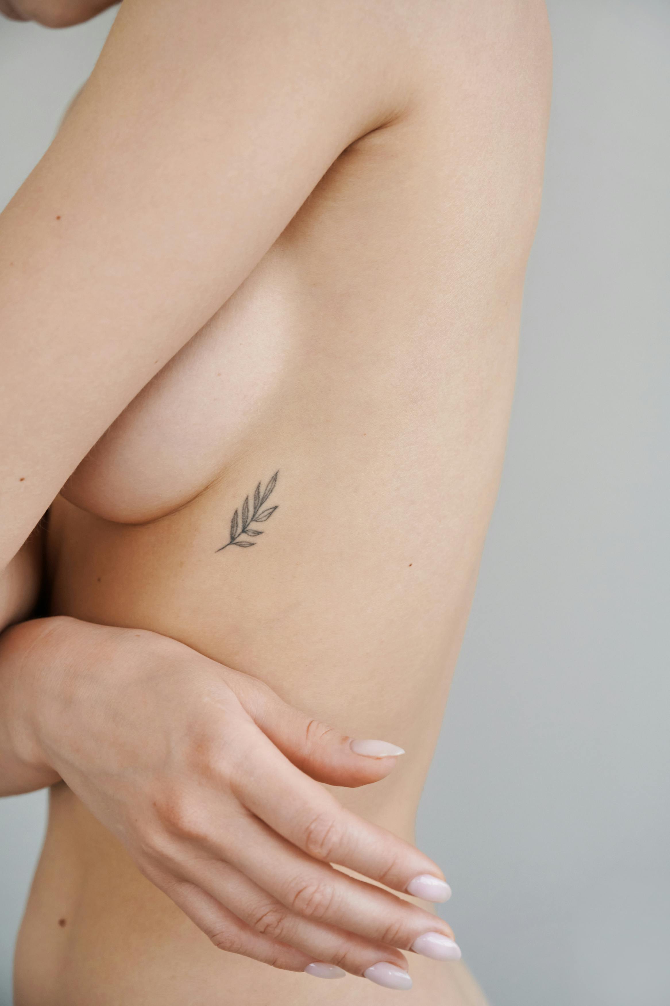 a topless woman with tattoo on her body