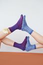 Woman in Blue Socks With Yellow Flowers on Her Lap