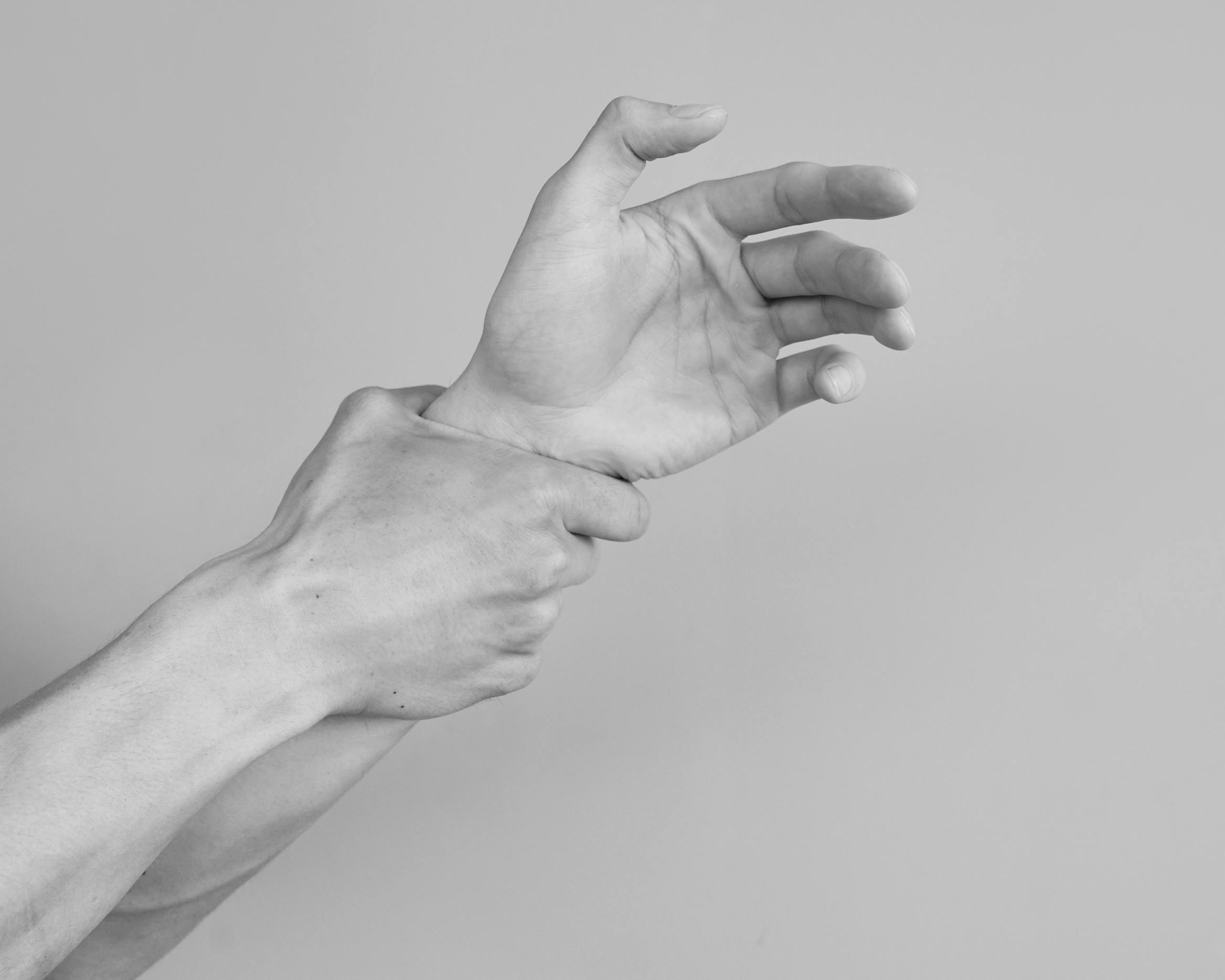 grayscale photograph of mans hands