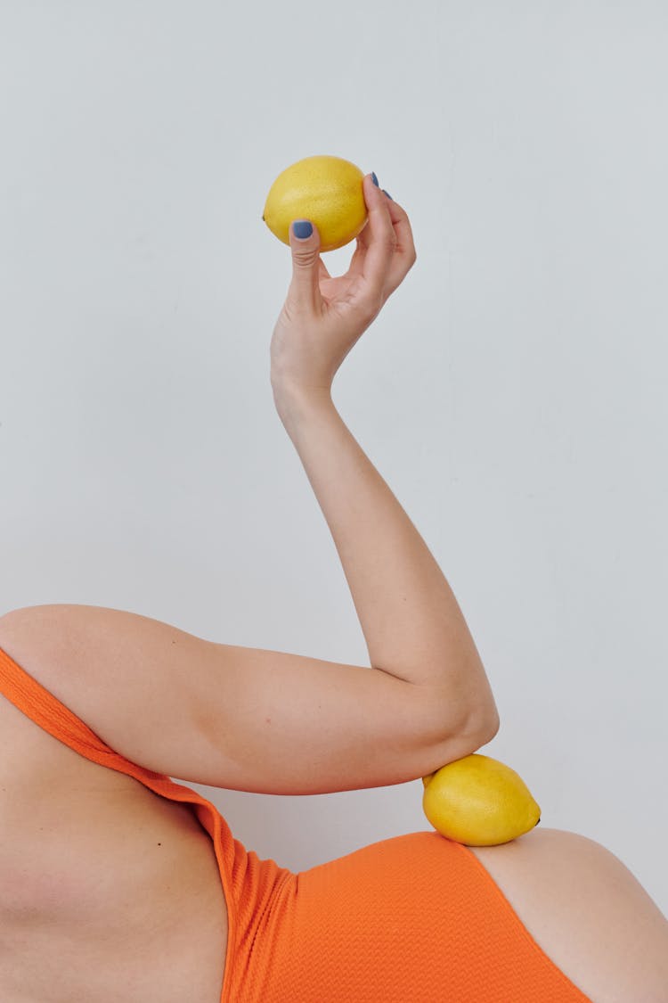 Woman In Orange Swimsuit With Lemons 