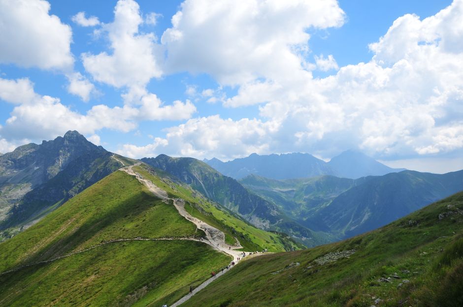 Hikers enjoying a scenic trail in the Tatra Mountains, Poland, emphasizing the need for activity-specific travel insurance.