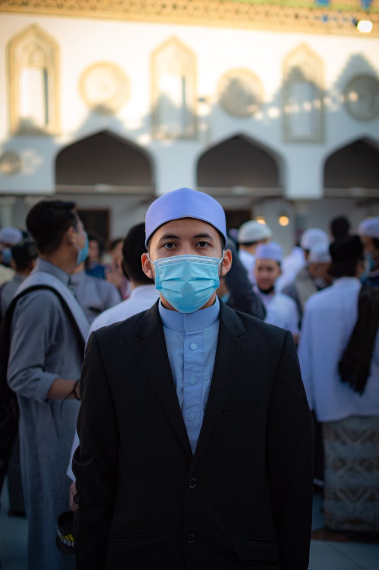 Man  In A Crowd Wearing A Facemask 