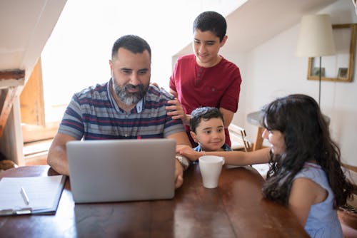 Free A Family Sitting at the Table Stock Photo