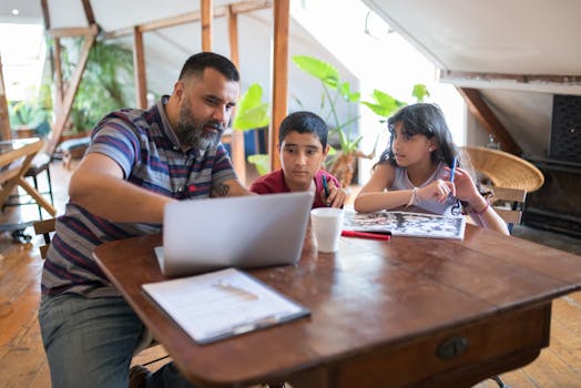 A father assists his children with homework on a laptop in a cozy home setting.