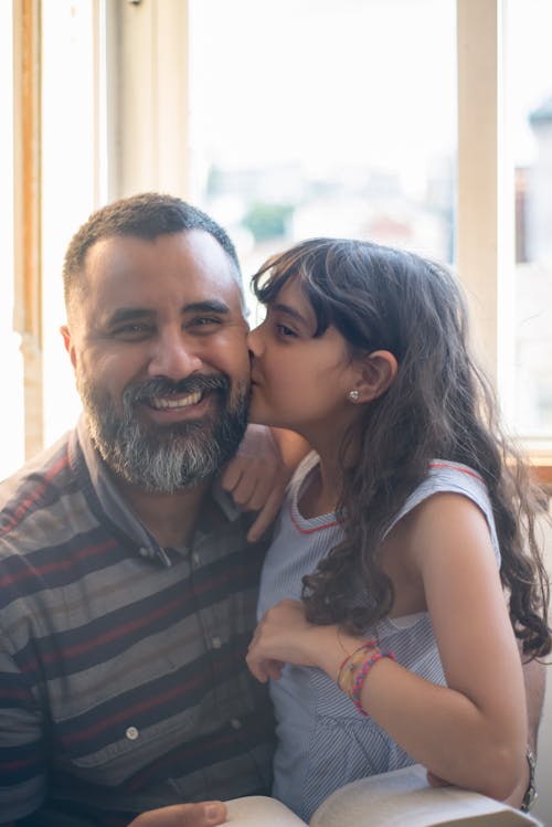 Free A Girl Kissing Her Father Stock Photo