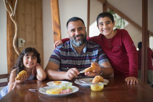 Free A Man Eating with his Children Stock Photo