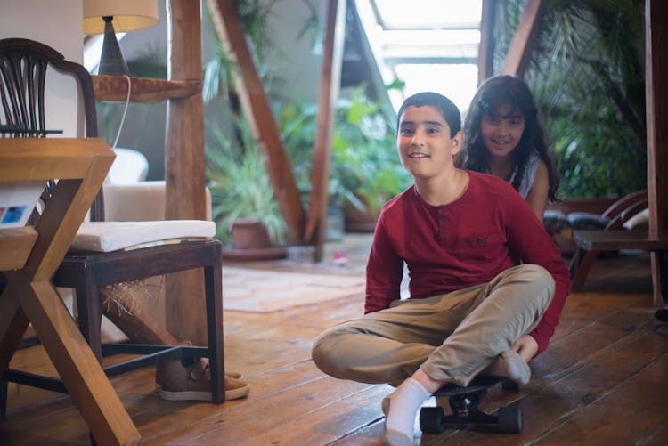 A Boy And Girl Playing The Long Board