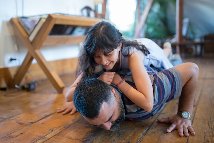 A Father Doing Push Up With His Daughter