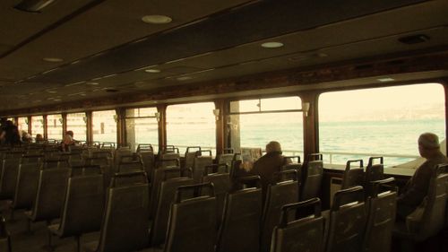 Free Quiet vintage ferry ride with passengers sitting, overlooking the sea. Stock Photo