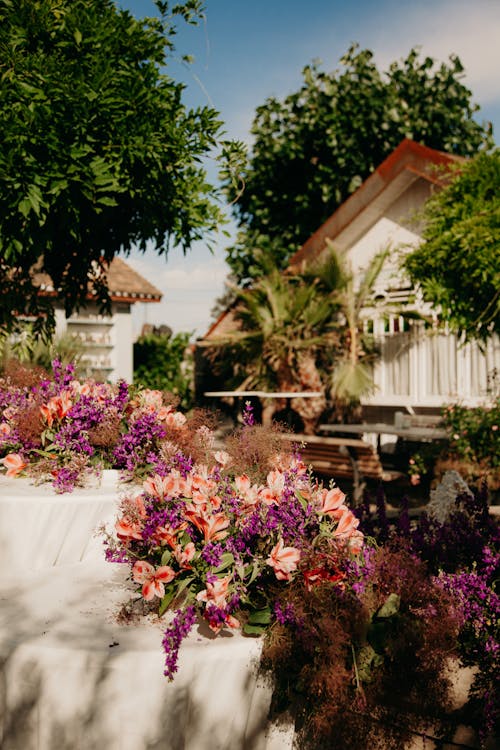 Bungalow in Trees and Pink Flowers on Patio