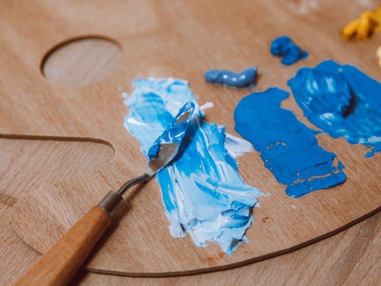 Close Up Of A Blue Paint Mixed On A Wooden Palette