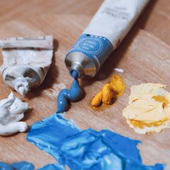 Blue paint squeezed from a tube onto a wooden palette