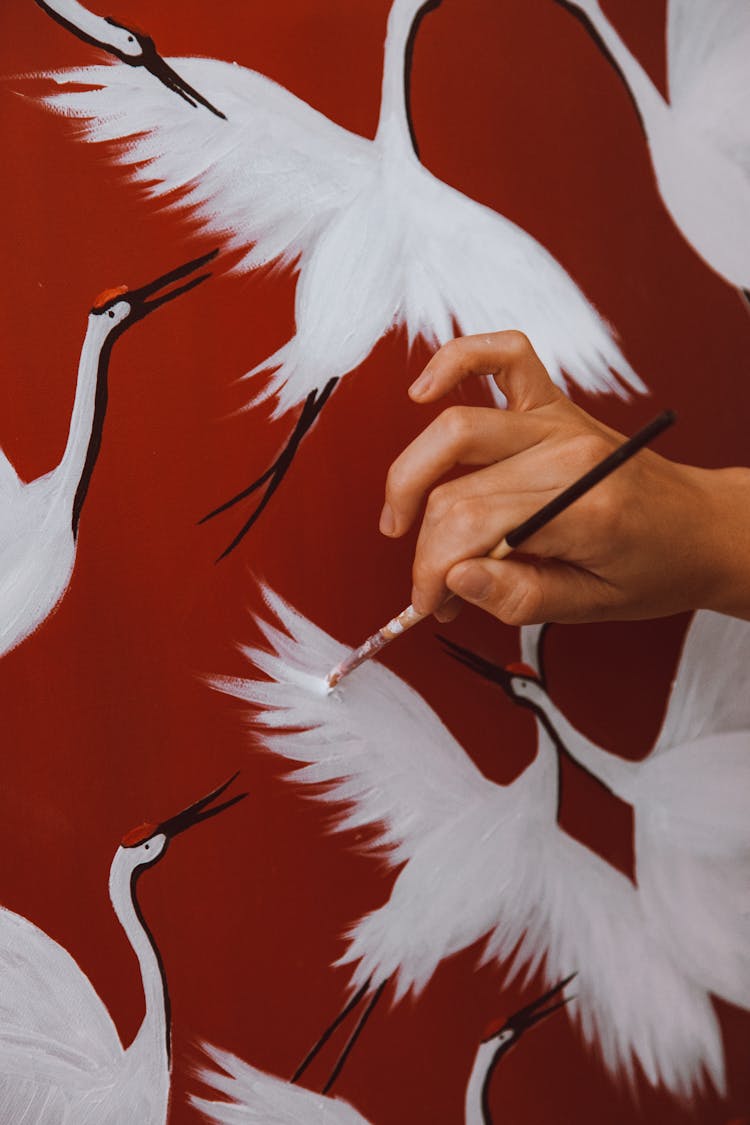 Hand Of A Person Painting White Birds