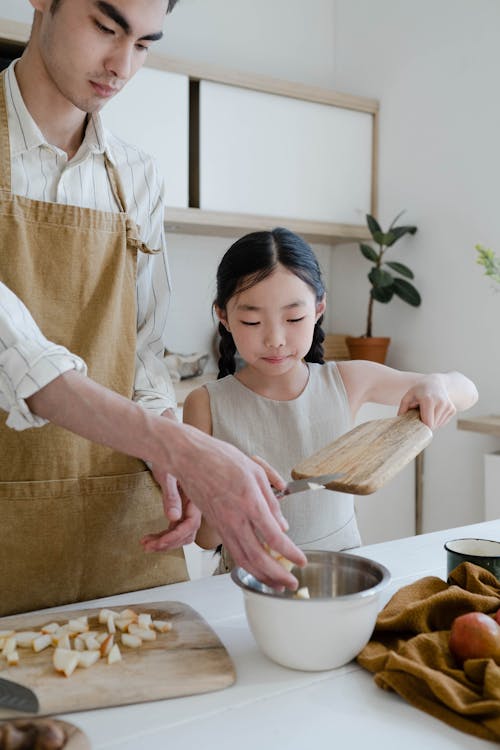 A Man Cooking with his Daughter